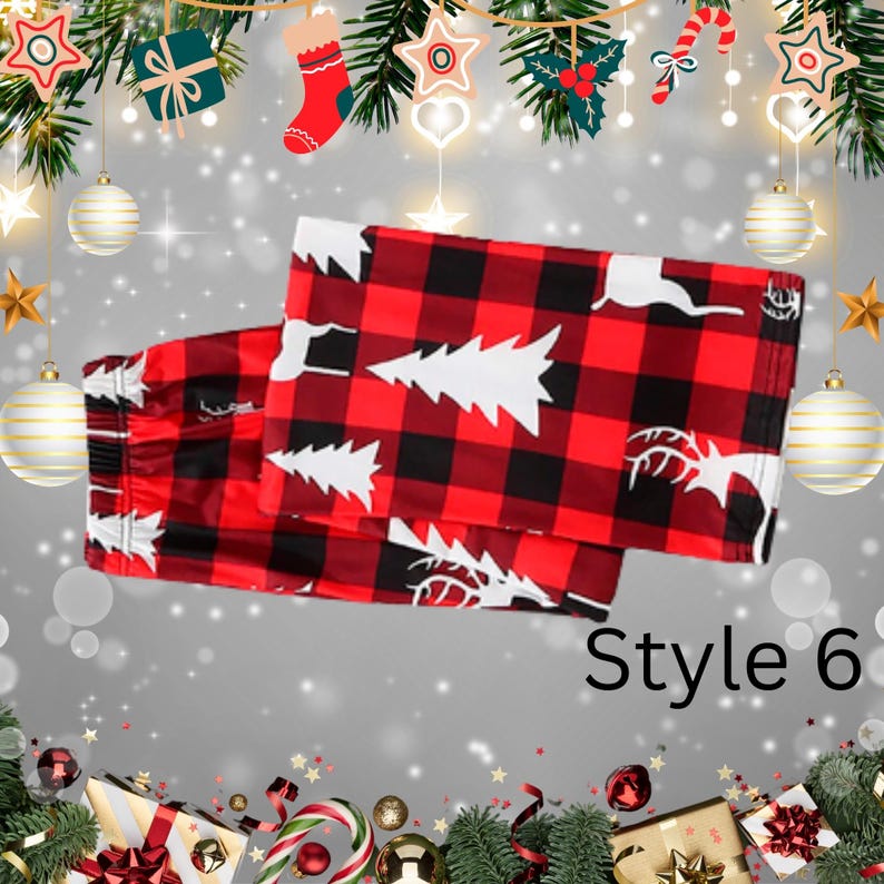 May include: Red and black plaid pajama pants with white Christmas tree and reindeer designs. The pants are folded and displayed on a festive background with holiday decorations. The text "Style 6" is visible.