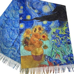 May include: A rectangular scarf with a print of Van Gogh's "Starry Night" and "Sunflowers." The scarf has a blue background with swirling patterns, a black cloud, and a vase of sunflowers. The scarf has a fringed edge.