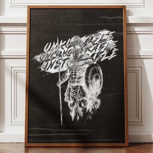 May include: Framed black and white artwork featuring a Spartan warrior with a spear and shield. The artwork has the words "UNSTOPPABLE, UNBREAKABLE" in a stylized font. The frame is a dark brown color.