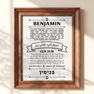 May include: A framed print featuring the name "BENJAMIN" and its meaning, derived from Hebrew words. The print includes a biblical verse and is set within a dark brown wooden frame. The text is in black.
