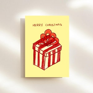 Handgezeichnete Weihnachtskarte mit gestreiftem Geschenk und Schleife Digitaler Download | Druckbar