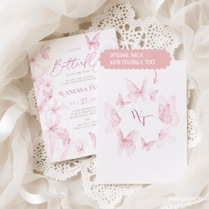 An elegant flat lay image featuring a soft pink baby shower invitation card surrounded by beautiful pink and white floral arrangements and paper butterfly decorations. The card includes delicate watercolor butterfly illustrations and sophisticated pink script typography that reads "A Little Butterfly is On the Way," inviting guests to a baby shower honoring Wanessa Tang. Soft shadows and natural light add depth to the image, creating a romantic, refined.