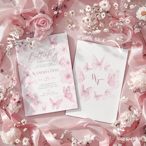 An elegant flat lay image of a soft and delicate pink-themed baby shower invitation. The invitation card features graceful watercolor pink butterflies, gentle florals, and refined script text that reads "A Little Butterfly Is On The Way," honoring Wanessa Tang. Surrounding the invitation are romantic details including blush pink silk ribbons arranged gracefully, fresh white and soft pink flowers, baby's breath, and delicate sprigs spread artistically across a pastel pink background.