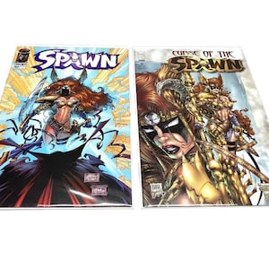 May include: Two comic books featuring Spawn characters. The first comic book cover has a female character with red hair, a mask, and a sword. The second comic book cover is titled "Curse of the Spawn" and features a group of armored characters.