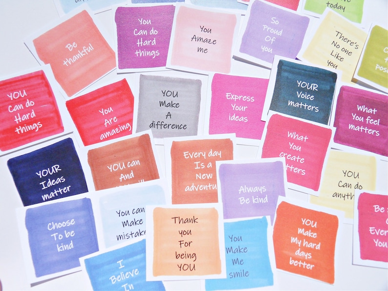 May include: A collection of square cards featuring watercolor-style backgrounds in various colors, each printed with motivational phrases such as Be thankful, You can do hard things, You amaze me, So proud of you, Your voice matters, and Choose to be kind.