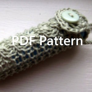 May include: A crocheted beige and blue case with a button closure and a loop handle. The case is labeled "PDF Pattern".