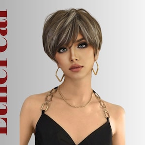 May include: A woman with a short, layered wig in shades of brown and blonde. She wears gold geometric earrings and a gold necklace. The text "Ethereal" is printed vertically in red on the left side of the image.