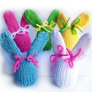 Colorful knit egg hat bunnies with bow ties.