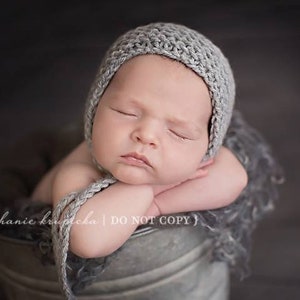 Beginner knitting pattern for a classic newborn bonnet hat. Quick and easy knitting project for a baby accessory and a photo prop.