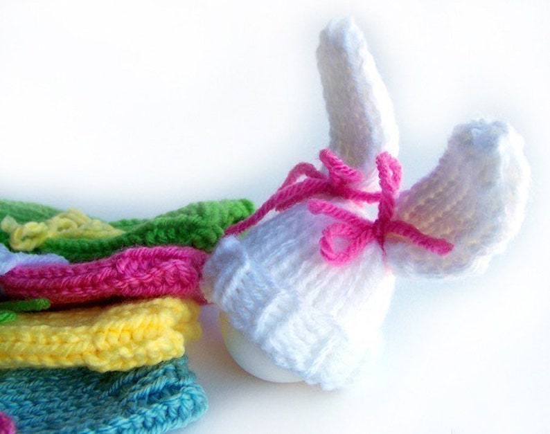 Colorful knit egg hat bunnies with bow ties.