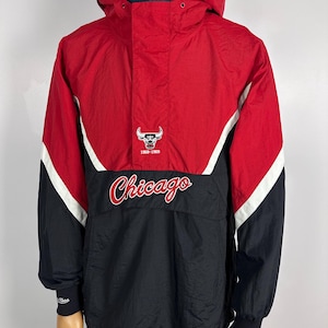 May include: A red, black, and white windbreaker jacket with a Chicago Bulls logo and the text "1991-1993 Chicago" on the front.