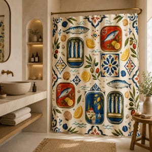 May include: A shower curtain with a repeating pattern of sardines, lemons, olives, and decorative tiles. The design includes images of sardines in cans, whole fish, and a coastal scene. The color palette is primarily cream, blue, red, and yellow.