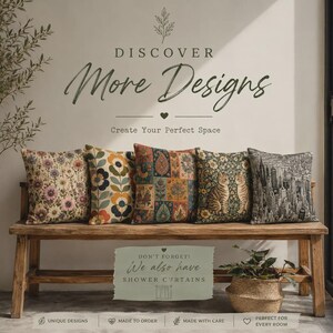 May include: Five square throw pillows arranged on a wooden bench. The pillows feature various patterns including floral prints, a cat illustration, and a city skyline. Text on the wall reads DISCOVER More Designs and Create Your Perfect Space.