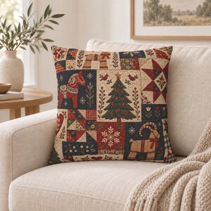 May include: A square throw pillow featuring a patchwork design with a holiday theme. The fabric displays illustrations of a red Dala horse, a green Christmas tree, a tan goat, red stars, snowflakes, and floral patterns in red, blue, and cream.