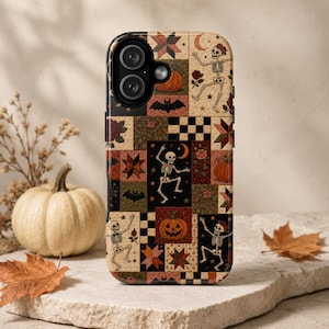 May include: A phone case featuring a patchwork design with various Halloween-themed illustrations including dancing skeletons, orange pumpkins, black bats, red roses, crescent moons, and geometric star and checkerboard patterns in earthy tones.