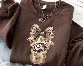 Dr Pepper Leopard Bow Shirt, Coquette Soda Can Graphic Tee, Funny Drink Lover Gift, Trendy Aesthetic Unisex Crewneck T-Shirt