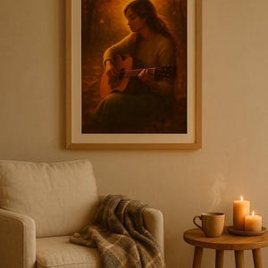 May include: A framed print showing a person playing an acoustic guitar. The artwork uses warm colours, highlighting the musician and instrument. The scene is set in a forest, with a soft, golden light. The print is displayed above a beige armchair, with a blanket and side table.