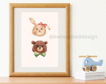 May include: A framed watercolor print featuring a brown bunny with a red bow and a brown teddy bear with a green bow tie. The print is on a white background and the frame is a light brown wood.