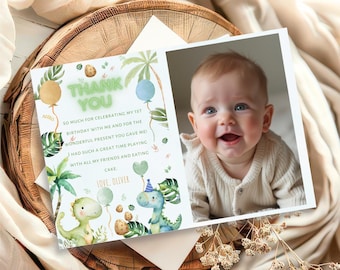May include: A thank you card with a green dinosaur illustration and a photo of a baby boy. The card reads "Thank You" and "So much for celebrating my 1st birthday with me and for the wonderful present you gave me! I had such a great time playing with all my friends and eating cake. Love, Oliver."