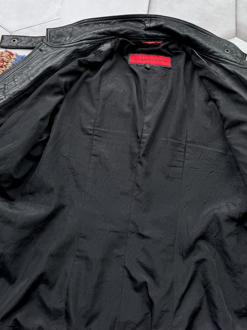 May include: Black leather jacket with a red label that says "Double Zero" inside the jacket.
