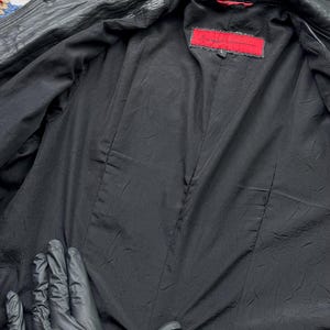 May include: Black leather jacket with a red label that says "Love Token" and a size "L" on it.