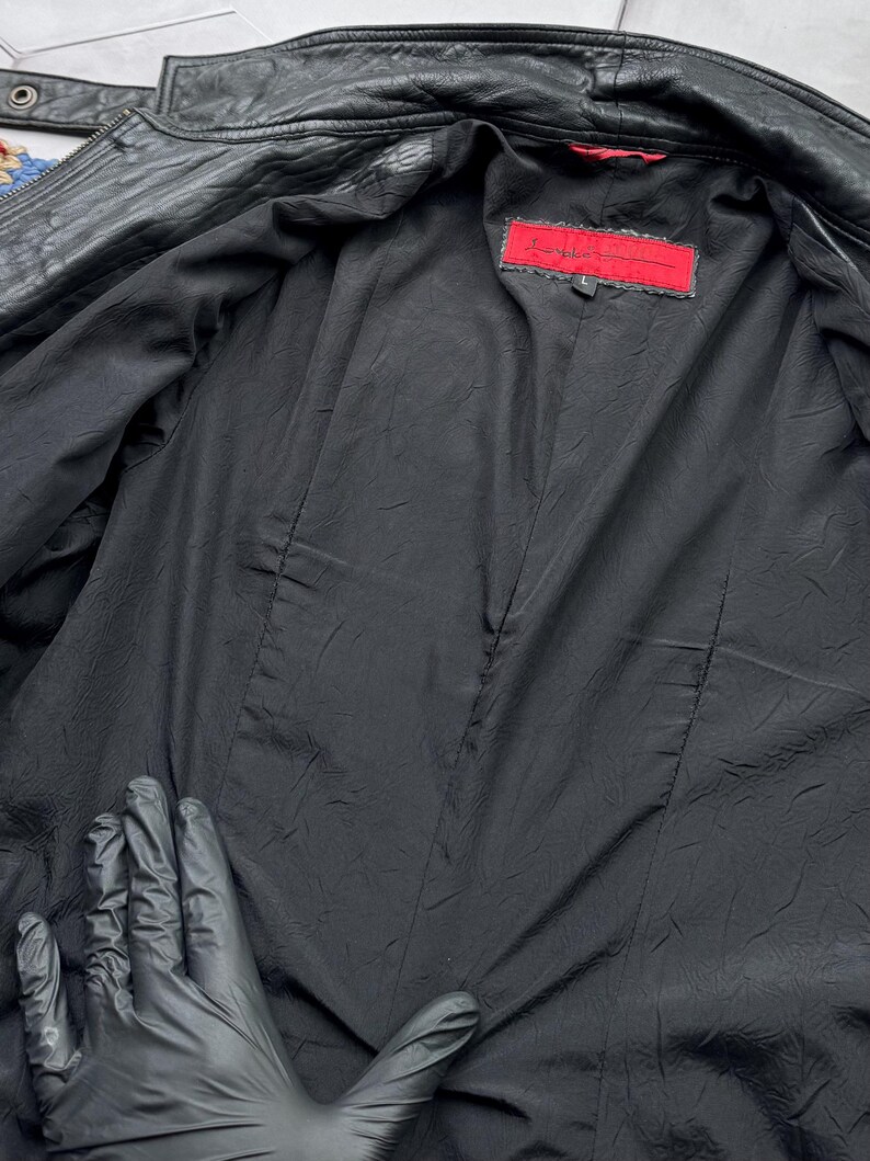 May include: Black leather jacket with a red label that says "Love Token" and a size "L" on it.