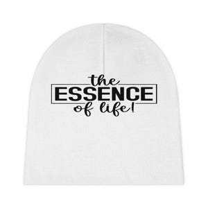 May include: White beanie with the text "the ESSENCE of life!" in black, centered on the front. The text is in a bold, sans-serif font, with "ESSENCE" enclosed in a black rectangle. The beanie is made of a soft, knit material.