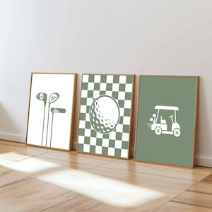 May include: Three framed prints with golf-themed designs. The first print features golf clubs, the second a golf ball on a checkered background, and the third a golf cart. All designs are in white on a neutral background.