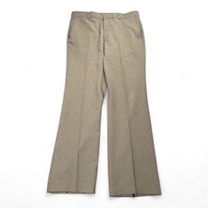 May include: Tan-colored, flared-leg trousers. The pants have a classic design with a button and zipper closure, belt loops, and front pockets. The fabric appears to be a medium-weight material, suitable for various occasions. The trousers are displayed on a white background.