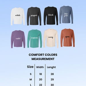 May include: Image of a color chart for Comfort Colors unisex long sleeve shirts. Colors include white, pepper, black, blue jean, violet, seafoam, ivory, and yam. Measurements are provided for sizes S-2XL, with width and length in inches.
