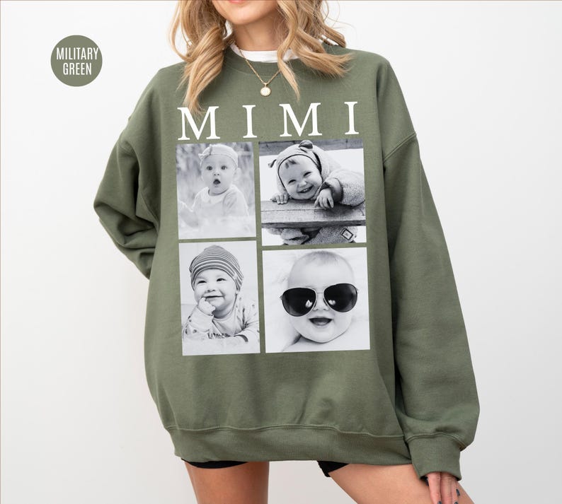 May include: Military green sweatshirt with the word "MIMI" in white block letters. The sweatshirt features four black and white photos of babies. One baby is wearing sunglasses. The sweatshirt is a casual style.