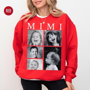 May include: A red sweatshirt with the word "MIMI" in white block letters. The sweatshirt features a grid of four black and white photos of children. The photos are framed in red. The sweatshirt is a crew neck style.