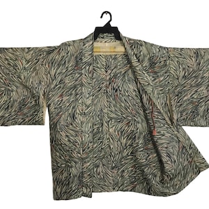 May include: A traditional Japanese kimono with a green, black and white abstract feather pattern.