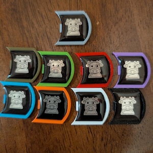 Various colored Mooey badges