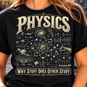 May include: A black t-shirt featuring a graphic print with the text PHYSICS and WHY STUFF DOES OTHER STUFF. The design includes various scientific illustrations such as an atom, planetary orbits, mathematical equations, and a light prism.