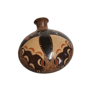 May include: A brown ceramic vase with a rounded shape and a decorative design featuring a butterfly motif in shades of brown, orange, and white.
