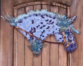 May include: A blue and purple horse head Christmas decoration with a gold bridle and snowflake embellishments.