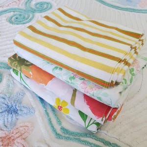 May include: A trio of ceramic mugs with a speckled, matte finish in cream, light grey, and dark grey. Each mug features a simple, minimalist design, ideal for tea or coffee.