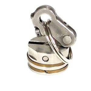 May include: A silver metal bottle stopper with a ring and a silver metal clip. The clip has the number "64962" engraved on it.