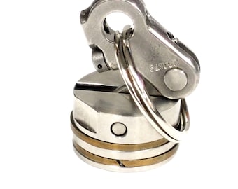 May include: A silver metal bottle stopper with a ring and a silver metal clip. The clip has the number "64962" engraved on it.