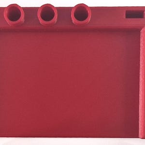 May include: A solid red desk organizer with three circular pen holders, a large open space, and a side section with multiple rectangular slots. The organizer is made of a matte material.