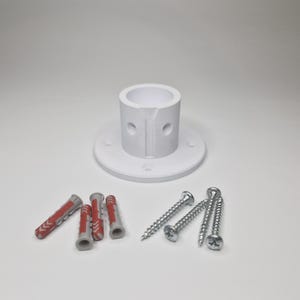 May include: A white cylindrical mounting bracket with a circular base featuring four screw holes. The bracket has a vertical slit and two side holes. Included are four grey and red plastic wall anchors and four silver metal screws.
