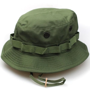 May include: A green military style boonie hat with a wide brim and a chin strap. The hat has a button on the top and a strap around the crown.