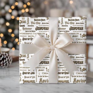 May include: A wrapped gift with white paper featuring religious words like "Jesus" and "Jehovah" in a repeating pattern. The gift is tied with a cream-colored satin ribbon and bow, perfect for a religious occasion.