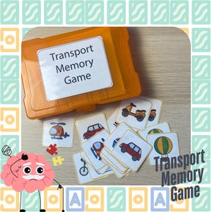 May include: A set of colorful cards for a Transport Memory Game. The cards feature various modes of transportation, including a helicopter, car, bicycle, scooter, and hot air balloon. The cards are arranged in a pile on a wooden table. The game is packaged in a bright orange plastic container with the words "Transport Memory Game" printed on the lid.