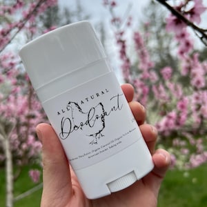 May include: White deodorant stick with a black label that reads "ALL NATURAL Deodorant". The label also lists the ingredients: Shea Butter, Organic Coconut Oil, Organic Yellow  Beeswax, Arrowroot Powder, Baking Soda.
