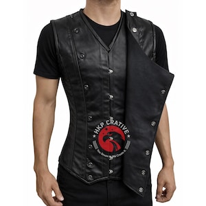 May include: Black leather vest with a double-breasted design and multiple silver-colored buttons. The vest has a V-neck and a fitted silhouette. The image includes the text "HKP Crativie" with a logo of an eagle.
