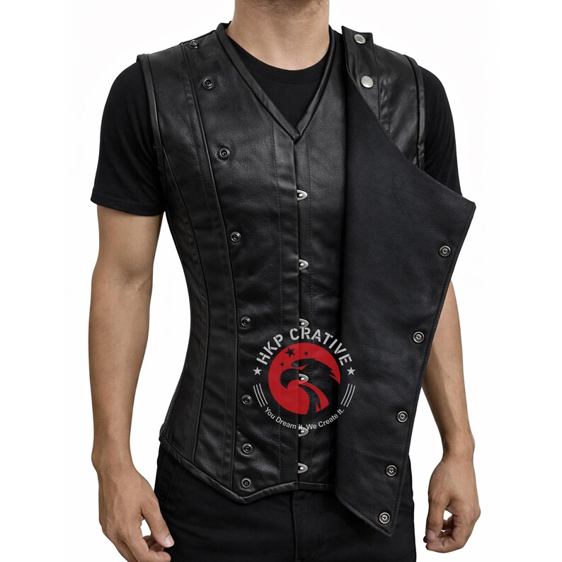 May include: Black leather vest with a double-breasted design and multiple silver-colored buttons. The vest has a V-neck and a fitted silhouette. The image includes the text "HKP Crativie" with a logo of an eagle.