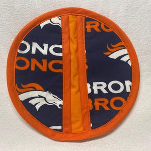May include: Orange and blue fabric pot holder with the Denver Broncos logo and the words "Broncos" and "ONC" repeated.