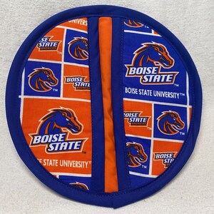 May include: A blue and orange pot holder with the Boise State University logo and the words "Boise State" and "Boise State University".